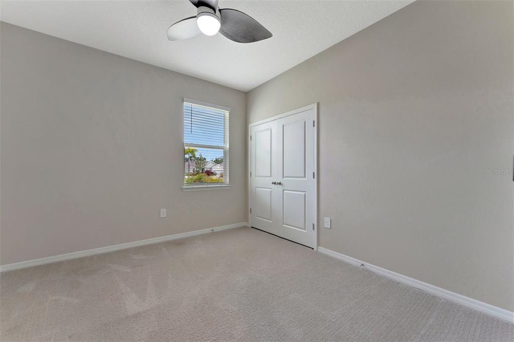 5210 Grove Mill Loop Lakewood Ranch, FL 34211 - Photo 28 of 48 an empty room with windows and fan