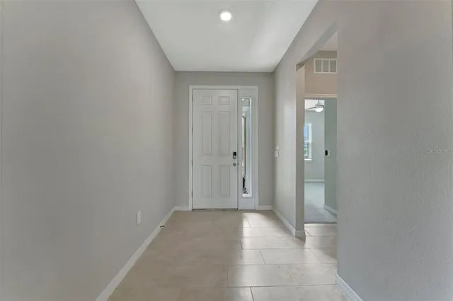 a view of a hallway with wooden shelves