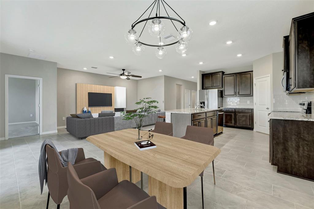 5210 Grove Mill Loop Lakewood Ranch, FL 34211 - Photo 35 of 48 a kitchen with stainless steel appliances kitchen island granite countertop a sink and cabinets