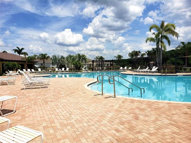 a view of swimming pool with outdoor seating