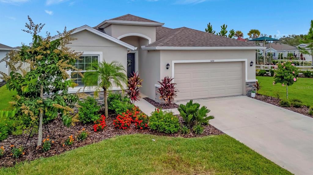 5210 Grove Mill Loop Lakewood Ranch, FL 34211 - Photo 7 of 48 a front view of a house with a yard