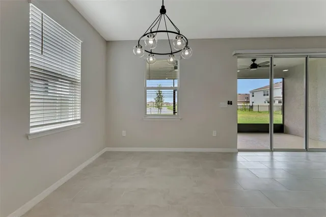 en empty room with wooden floor and windows