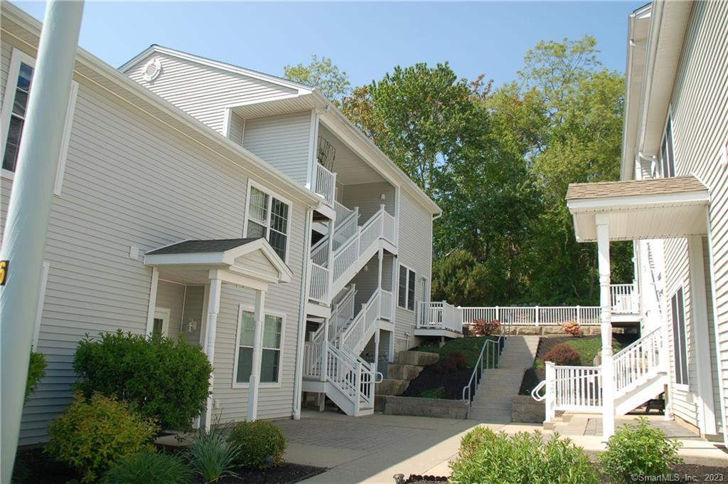 128 Meridian Street, Unit 212 Groton, CT 06340 - Photo 1 of 1 a view of a building with a yard