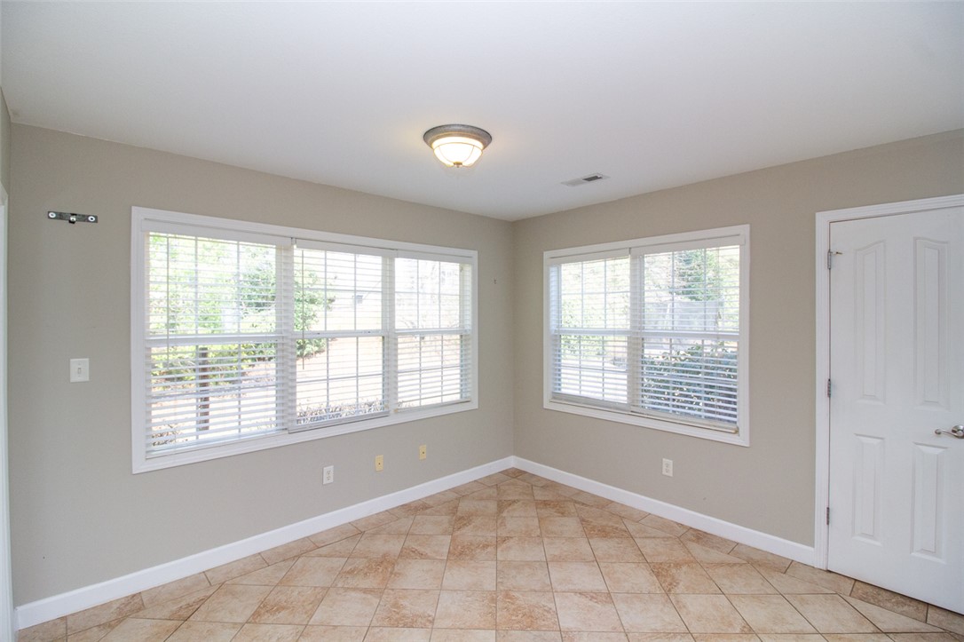 735 Britton Street Anderson, SC 29621 - Photo 18 of 50 This bright room features durable tile flooring and expansive windows, creating an inviting atmosphere.