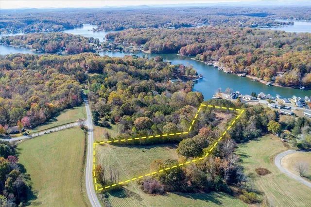 an aerial view of a houses with a lake view