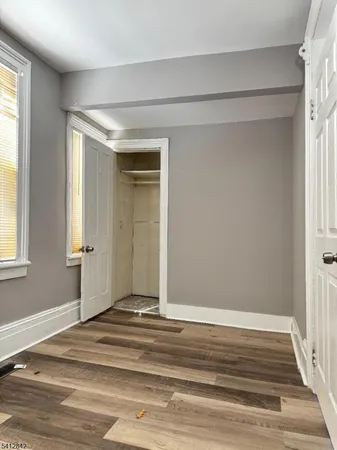 a view of a livingroom with wooden floor and window