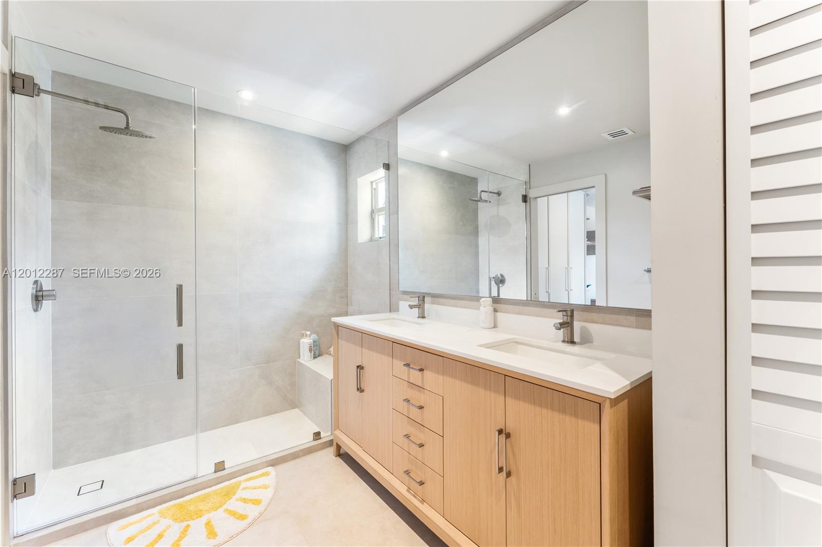 8763 Southwest 61st Place Pinecrest, FL 33156 - Photo 13 of 30 a spacious bathroom with a double vanity sink mirror and shower