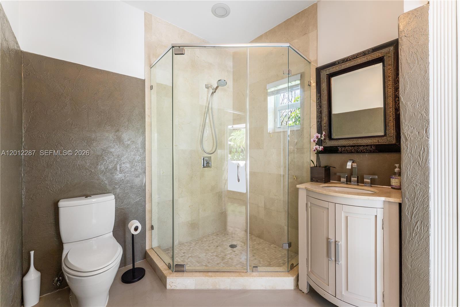 8763 Southwest 61st Place Pinecrest, FL 33156 - Photo 19 of 30 a bathroom with a shower a toilet and a sink