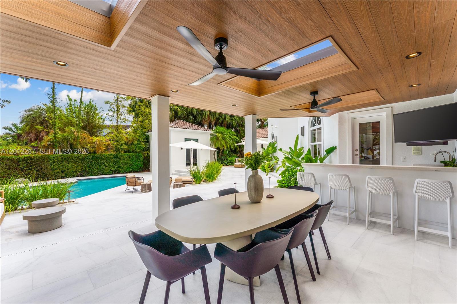 8763 Southwest 61st Place Pinecrest, FL 33156 - Photo 21 of 30 a view of an outdoor dining space with a table and chairs
