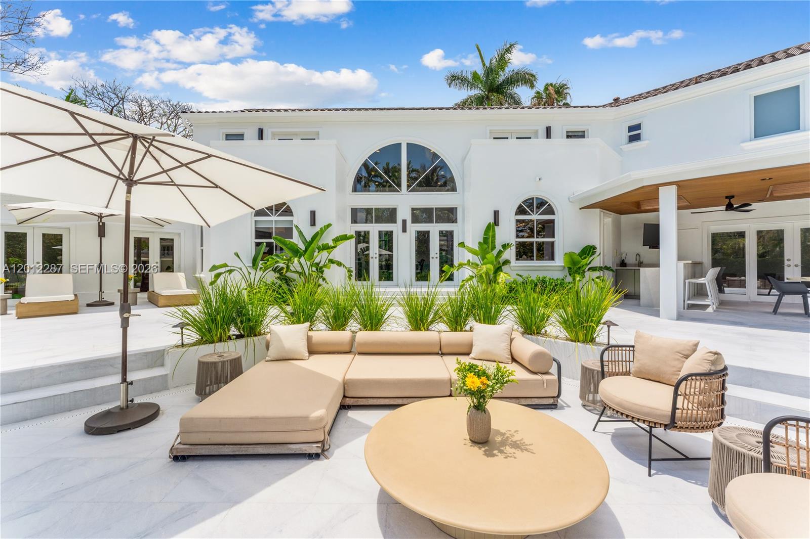 8763 Southwest 61st Place Pinecrest, FL 33156 - Photo 22 of 30 a outdoor living space with furniture and a potted plant