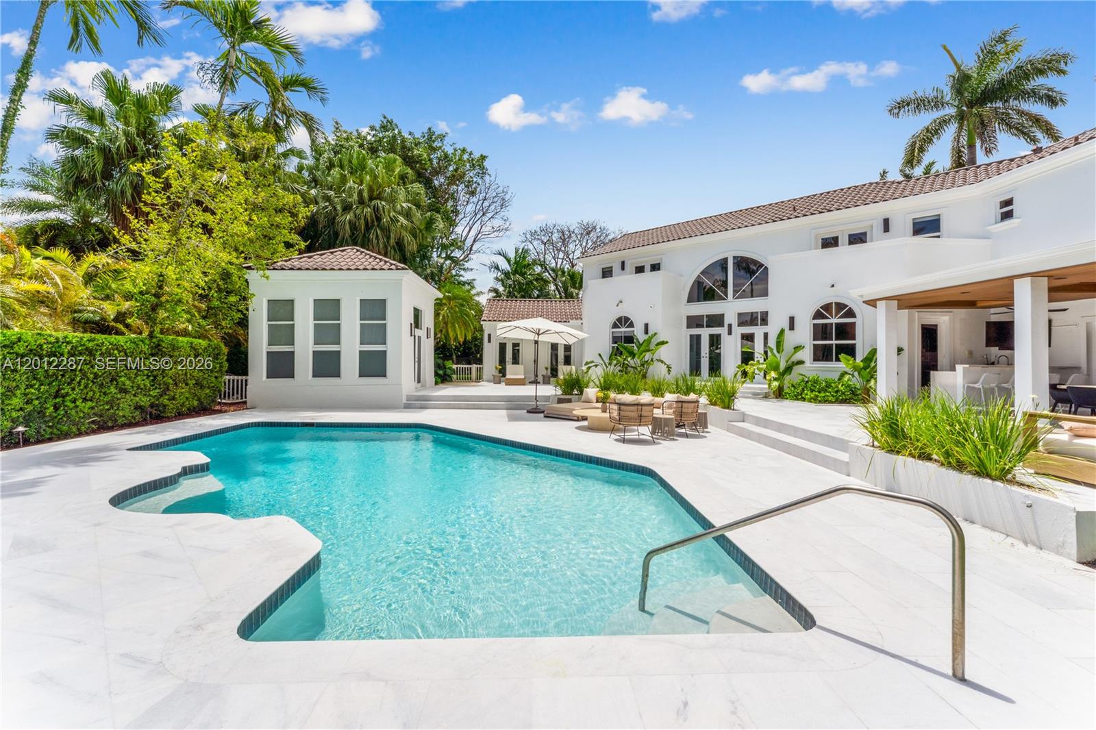 8763 Southwest 61st Place Pinecrest, FL 33156 - Photo 23 of 30 a swimming pool with outdoor seating and yard