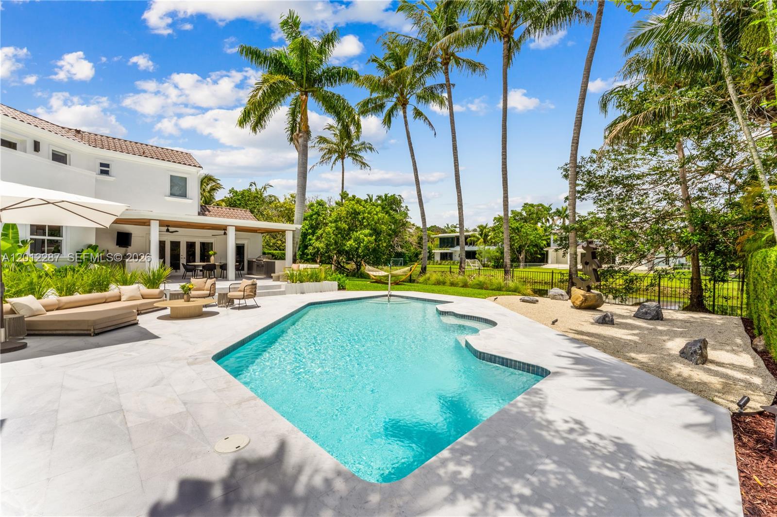 8763 Southwest 61st Place Pinecrest, FL 33156 - Photo 24 of 30 a view of swimming pool with outdoor seating and a patio