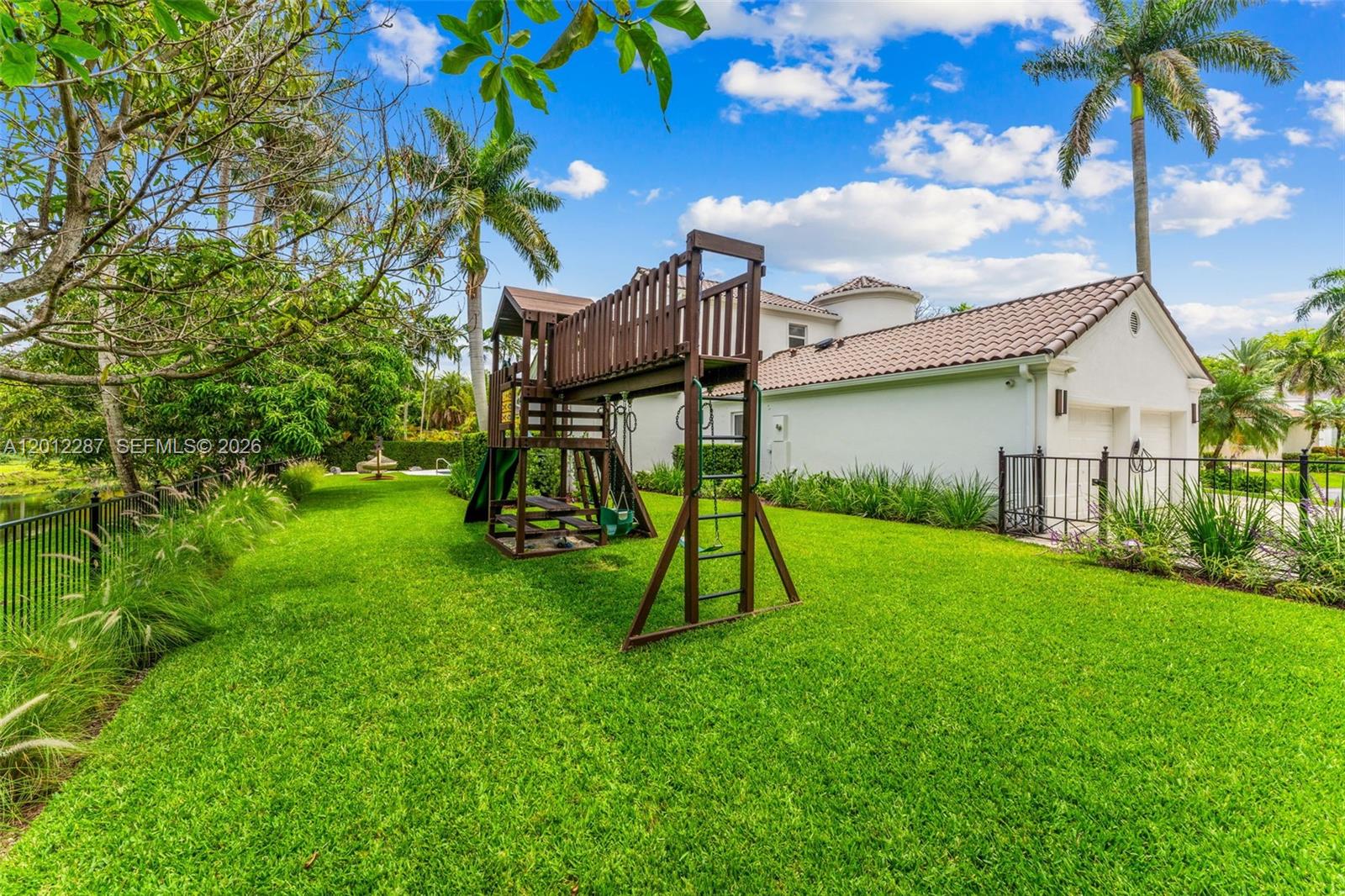8763 Southwest 61st Place Pinecrest, FL 33156 - Photo 27 of 30 a view of a garden with a slide