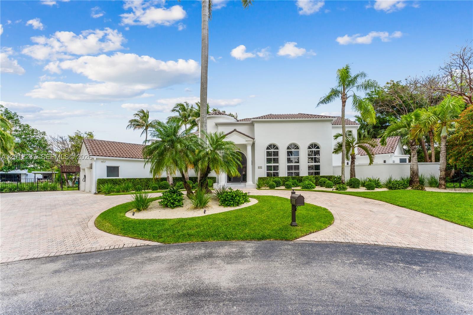 8763 Southwest 61st Place Pinecrest, FL 33156 - Photo 29 of 30 a view of a house with a swimming pool and a yard