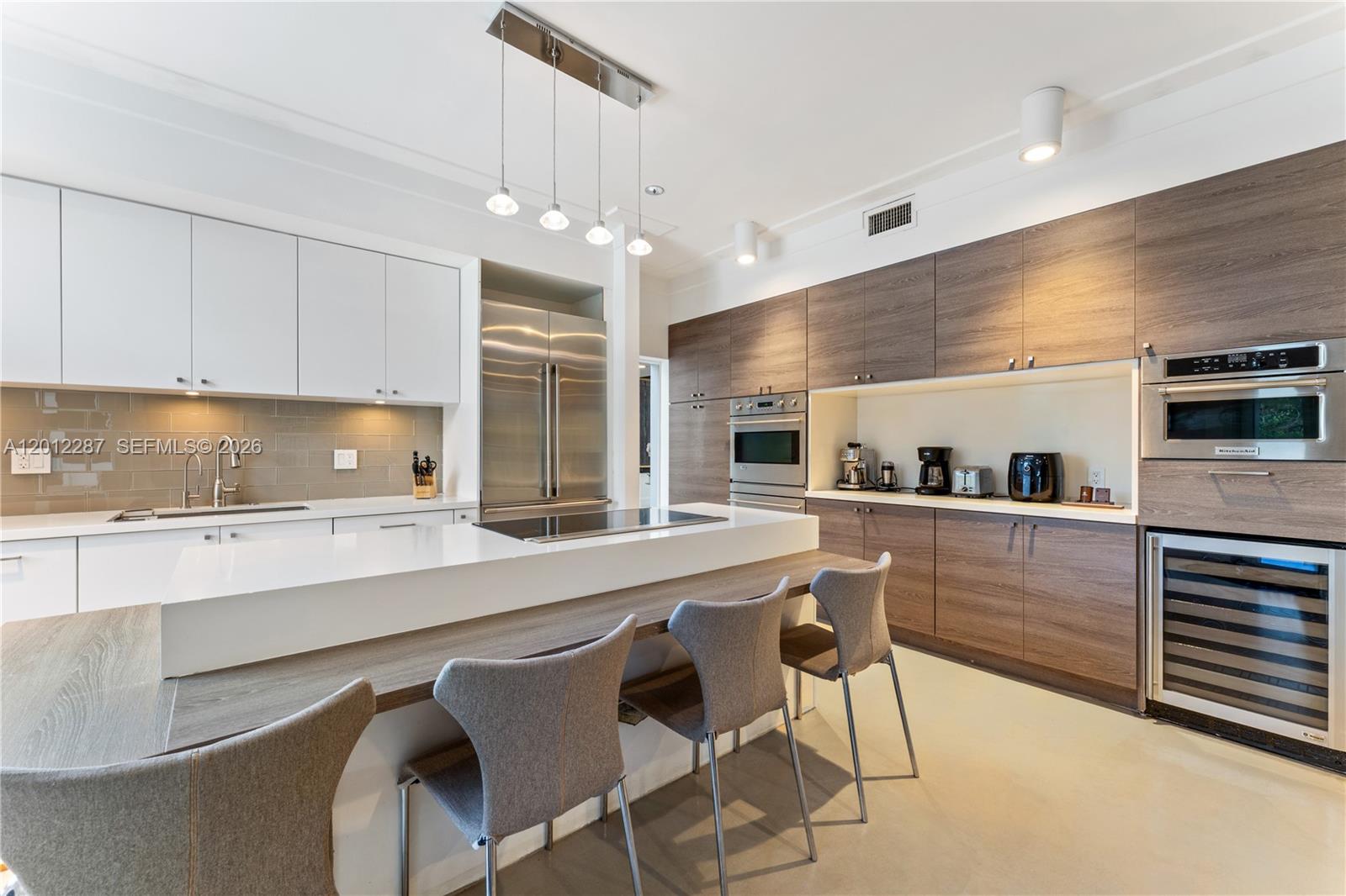 8763 Southwest 61st Place Pinecrest, FL 33156 - Photo 7 of 30 a kitchen with a sink stainless steel appliances and cabinets