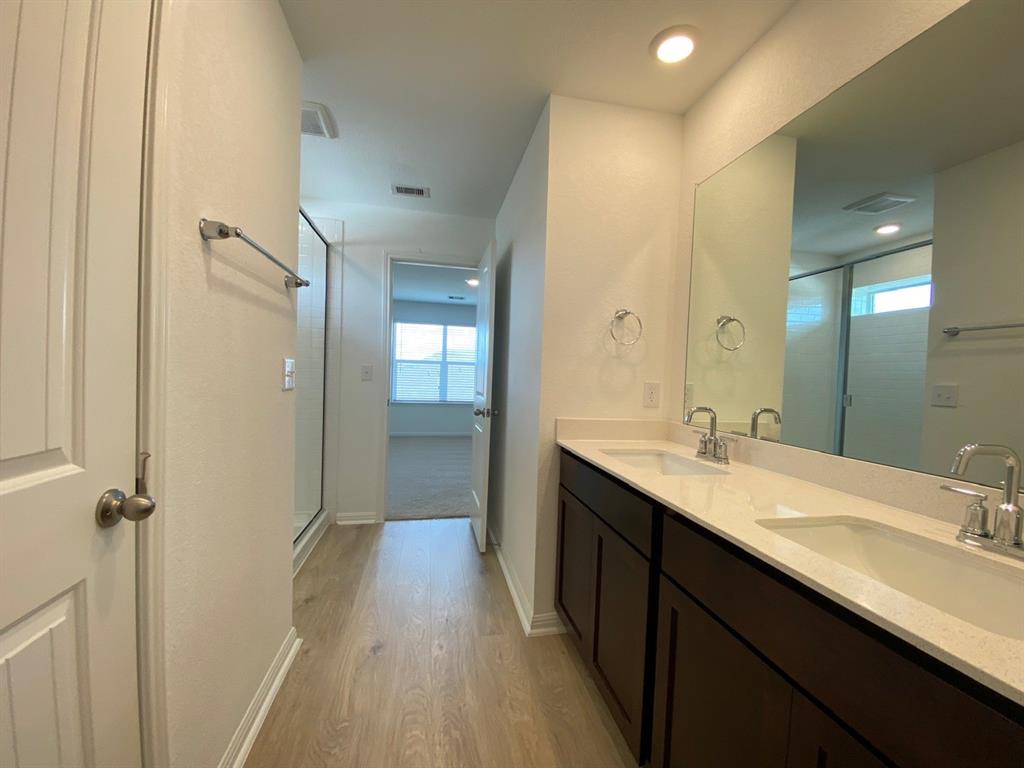 225 Saide Street Georgetown, TX 78626 - Photo 16 of 22 a bathroom with a double vanity sink a mirror and a shower