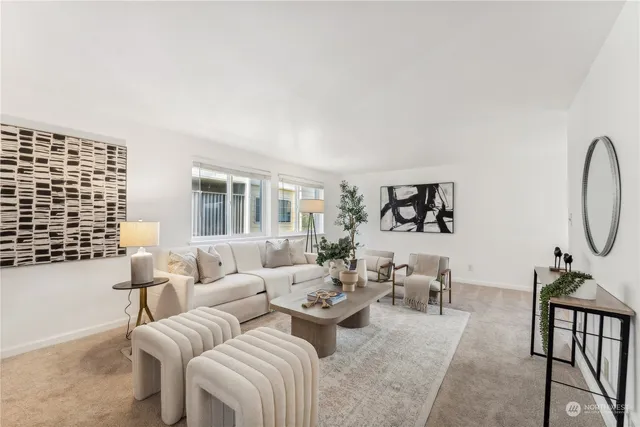 a living room with furniture a rug and white walls