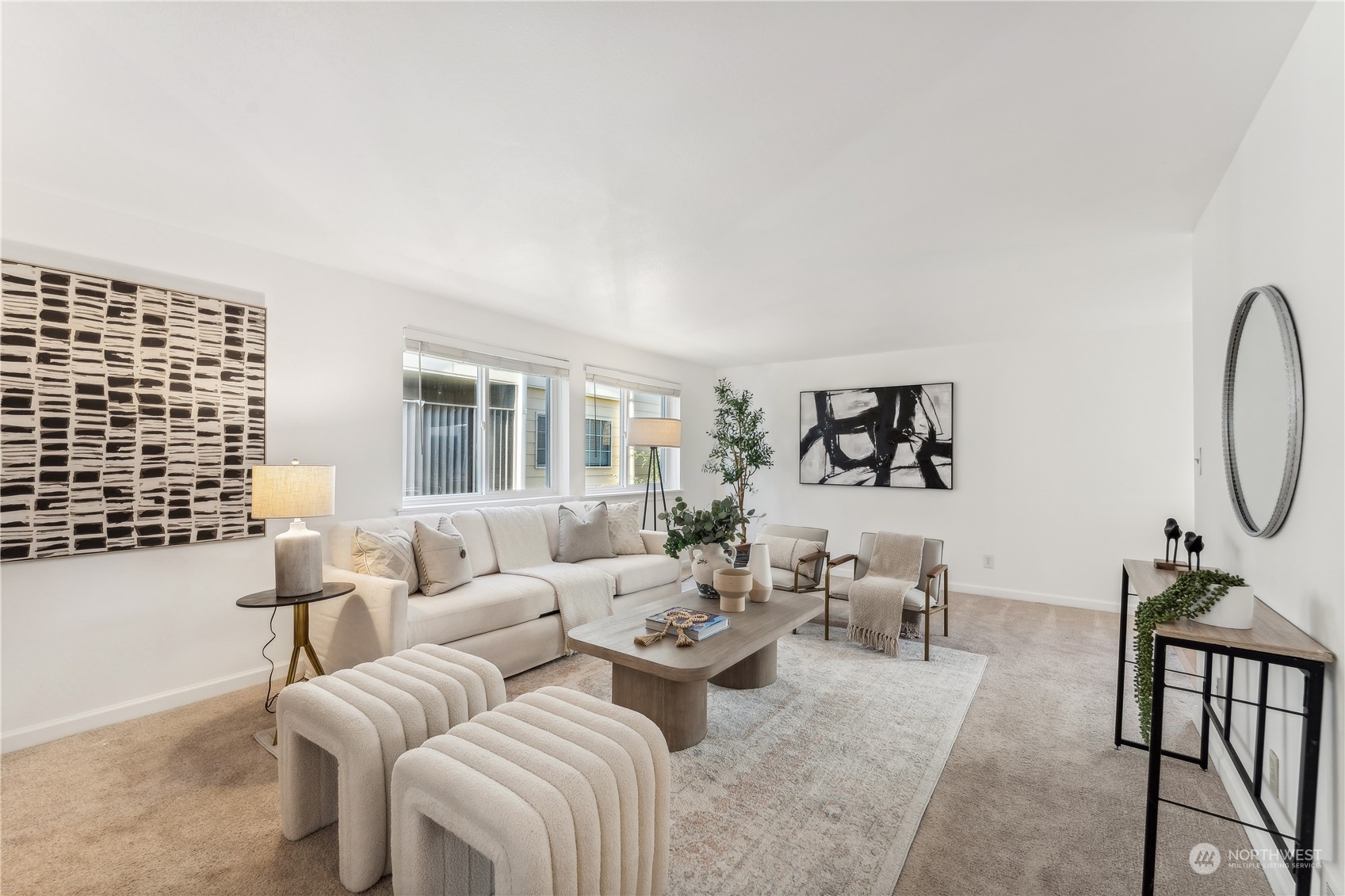 a living room with furniture a rug and white walls