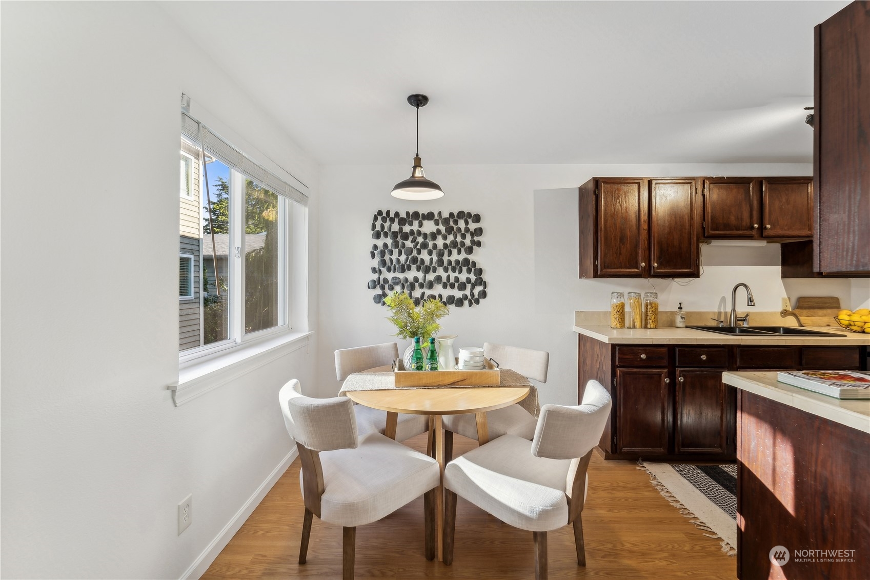 734 North 94th Street, Unit A3 Seattle, WA 98103 - Photo 12 of 20 a dining room with furniture a chandelier and window