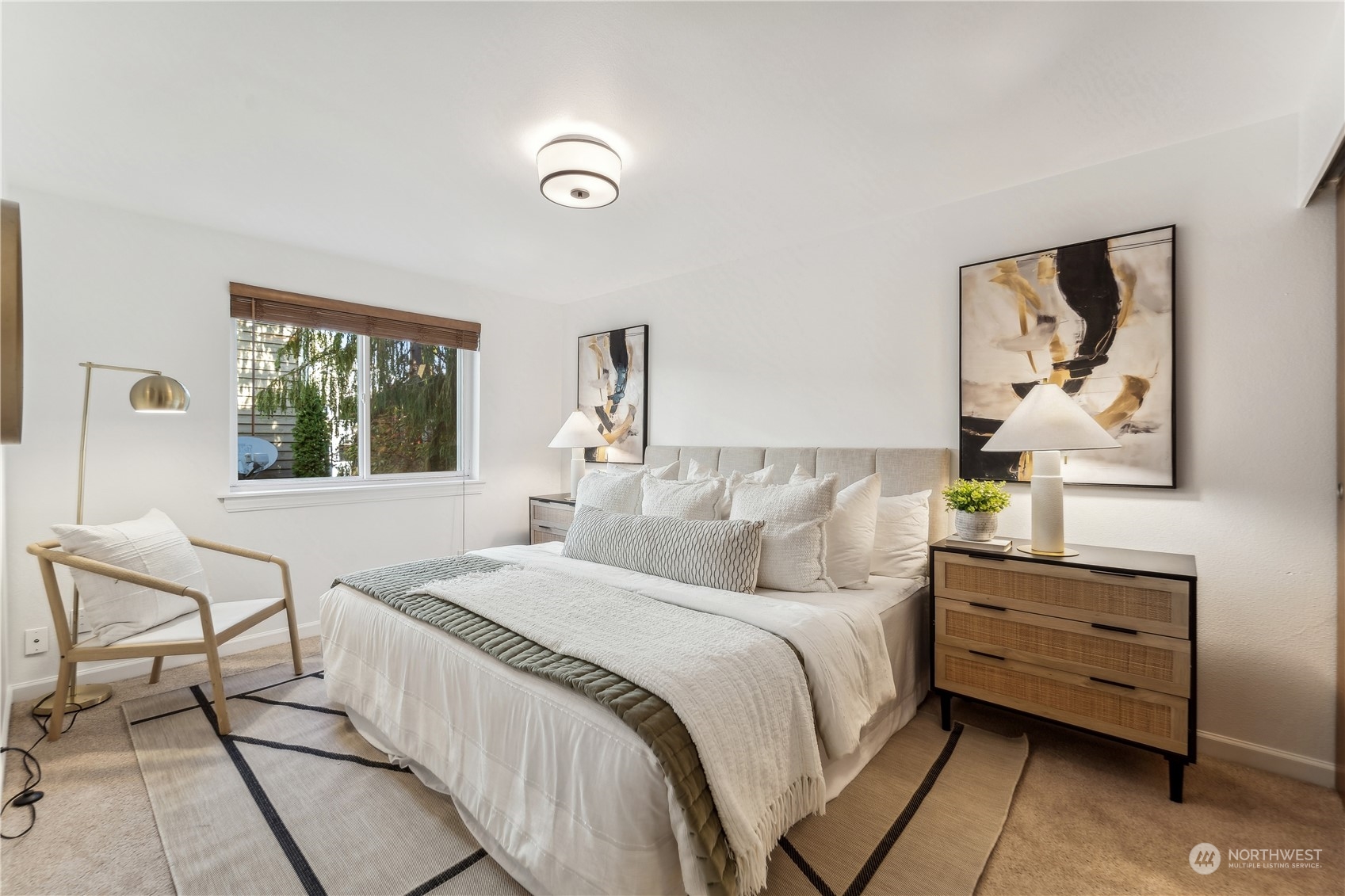 734 North 94th Street, Unit A3 Seattle, WA 98103 - Photo 15 of 20 a bedroom with a bed and a painting on the wall