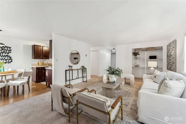 a living room with furniture a dining table and a flat screen tv