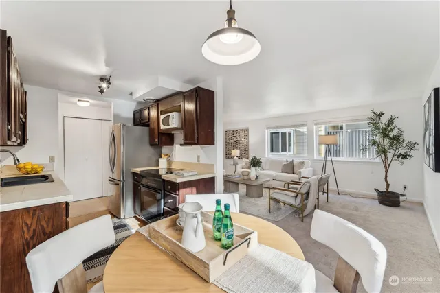 a living room with furniture a rug and a flat screen tv
