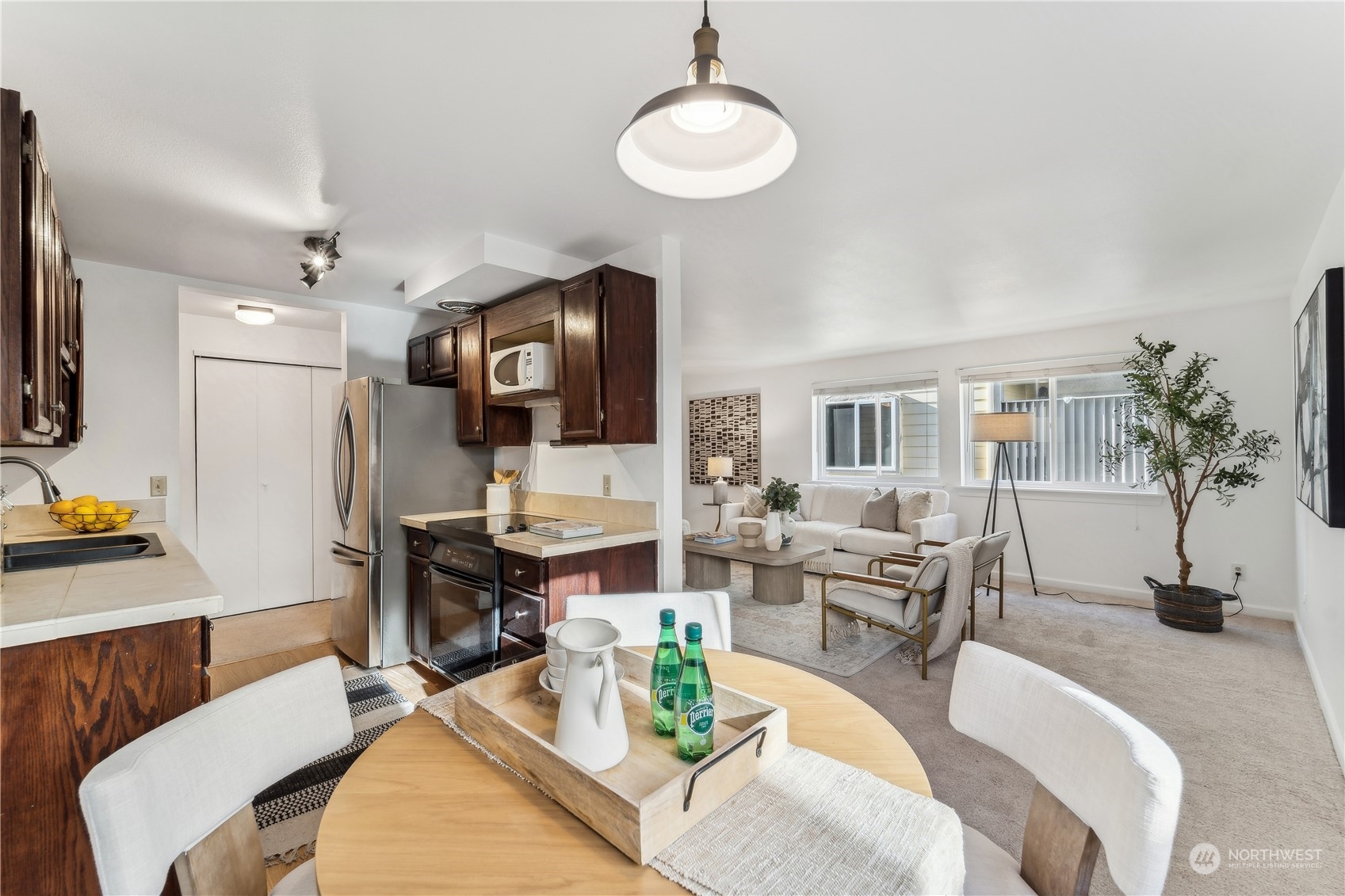 734 North 94th Street, Unit A3 Seattle, WA 98103 - Photo 10 of 20 a living room with furniture a rug and a flat screen tv