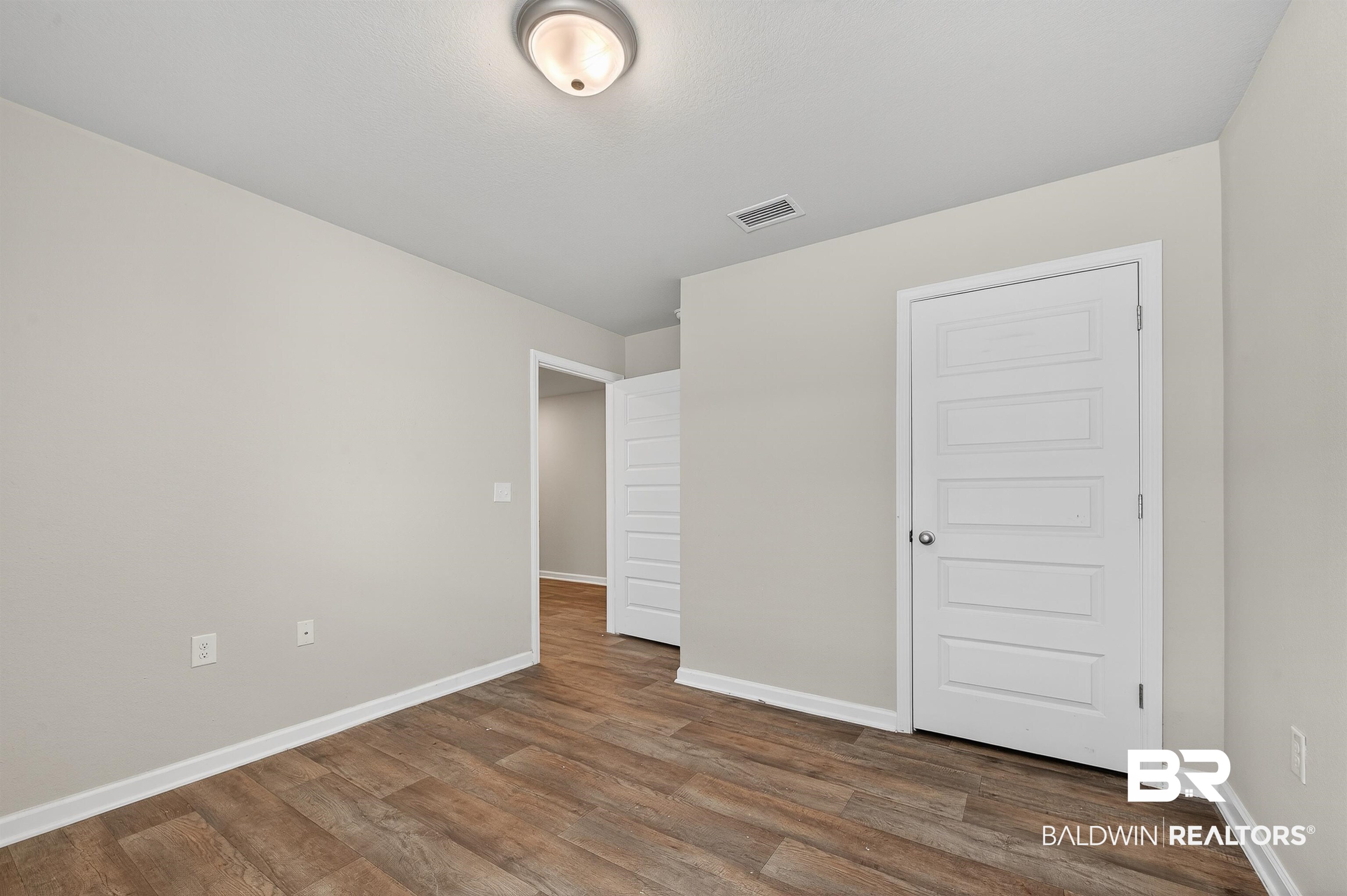 7429 Brompton Drive Foley, AL 36535 - Photo 39 of 50 Unfurnished bedroom with dark wood-style floors and a closet