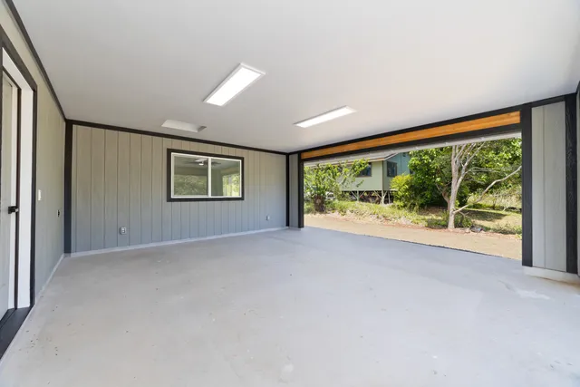 a view of a room with large windows and view of an outdoor space