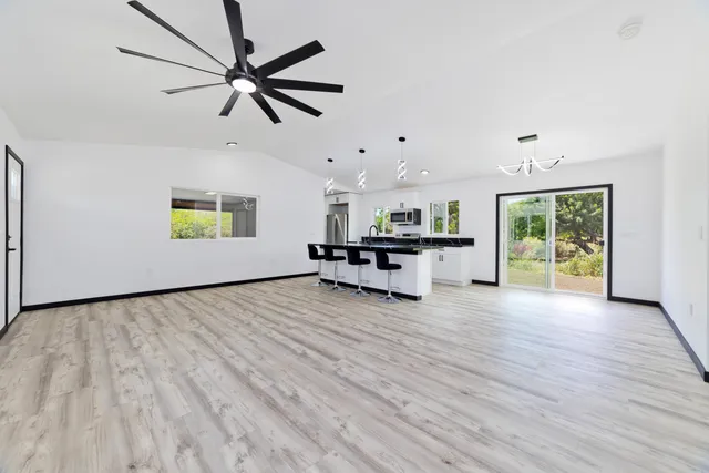 a kitchen with a counter space a sink appliances and wooden floor