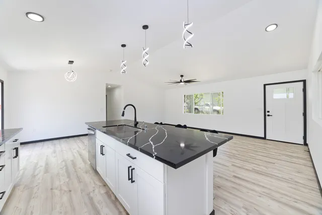 a living room with furniture and kitchen view