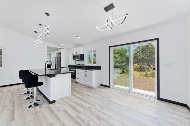 a bathroom with a granite countertop sink toilet a mirror and shower