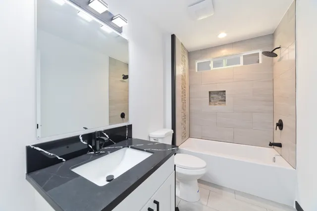 an empty room with ceiling fan and window