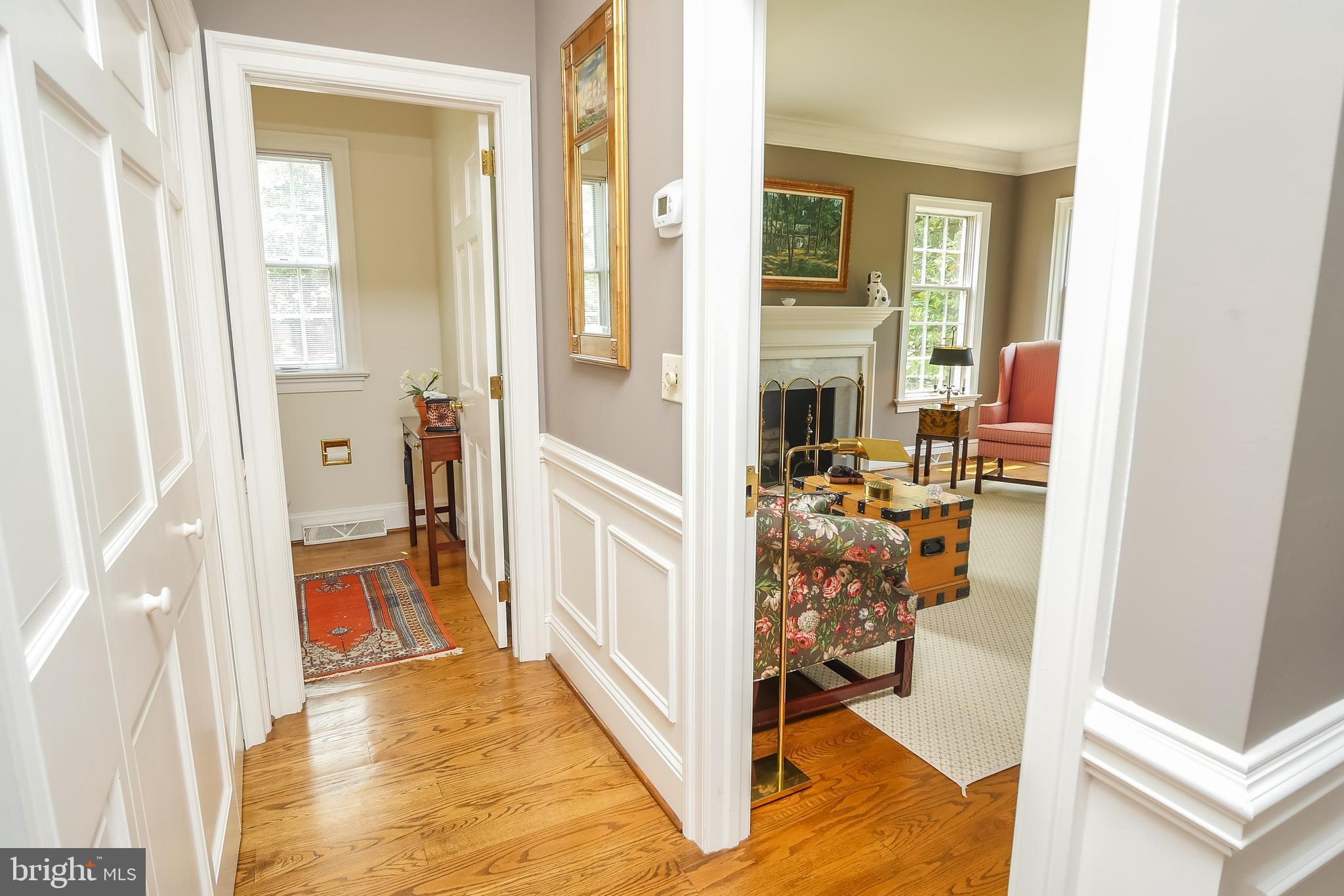 234 Pine Valley Road Dover, DE 19904 - Photo 10 of 48 a view of a hallway with wooden floor and livingroom with furniture