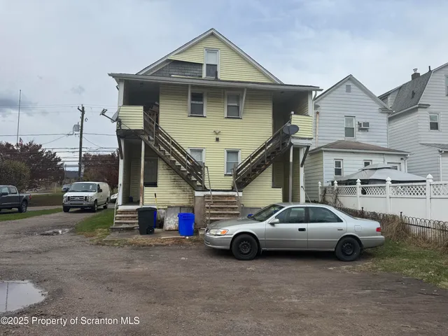 a view of a car parked in front of a house