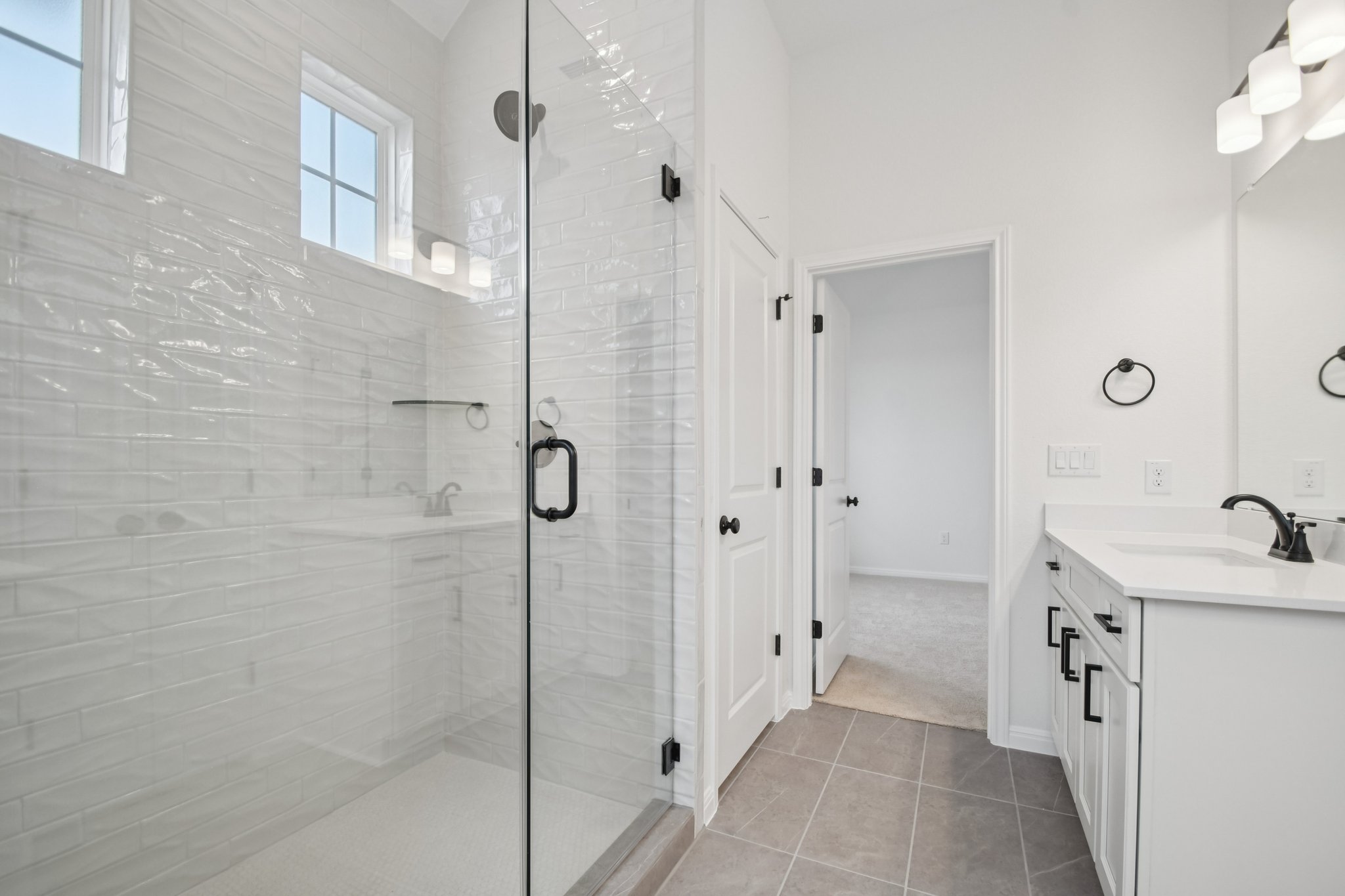 6385 Marsh Lane Buda, TX 78610 - Photo 17 of 35 a bathroom with a sink and shower