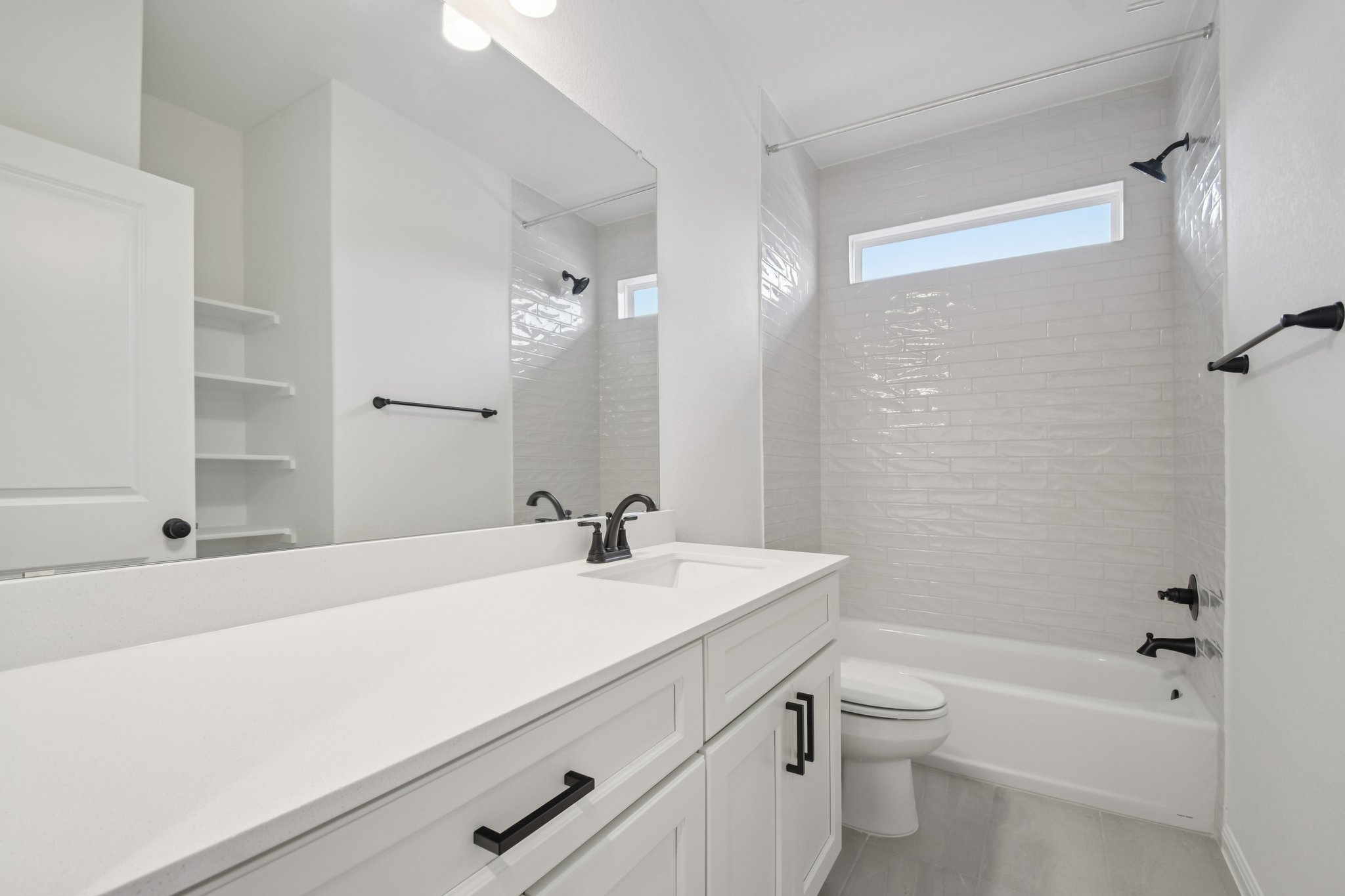 6385 Marsh Lane Buda, TX 78610 - Photo 19 of 35 a bathroom with a sink a toilet and shower