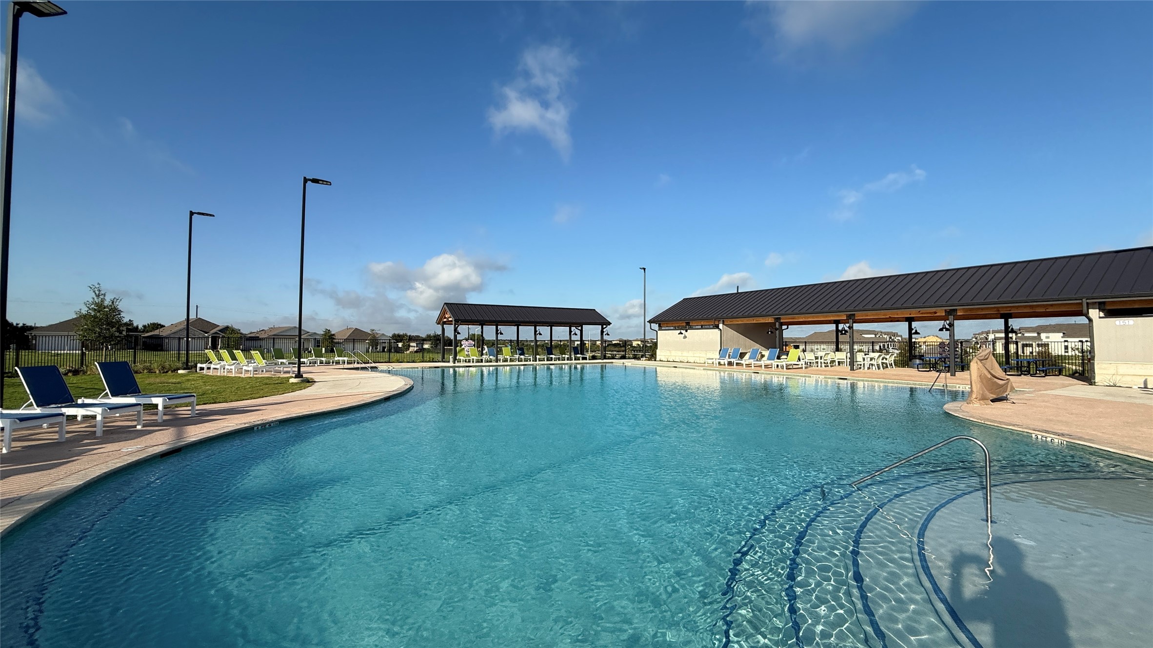 6385 Marsh Lane Buda, TX 78610 - Photo 34 of 35 a view of a swimming pool and lounge chairs
