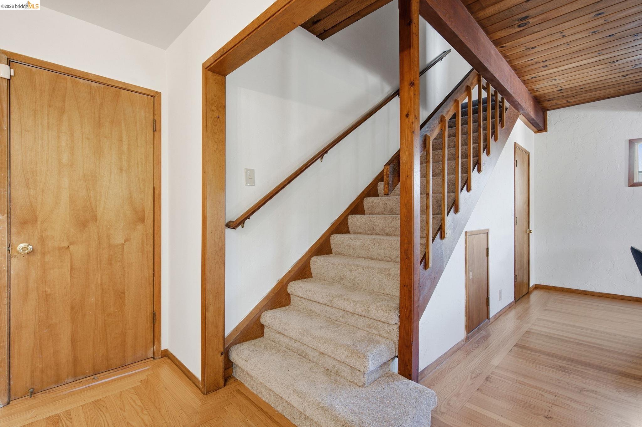 4522 Santa Rita Road El Sobrante, CA 94803 - Photo 32 of 58 Carpeted staircase with wood railing, wood-finish flooring, and wood panel ceiling