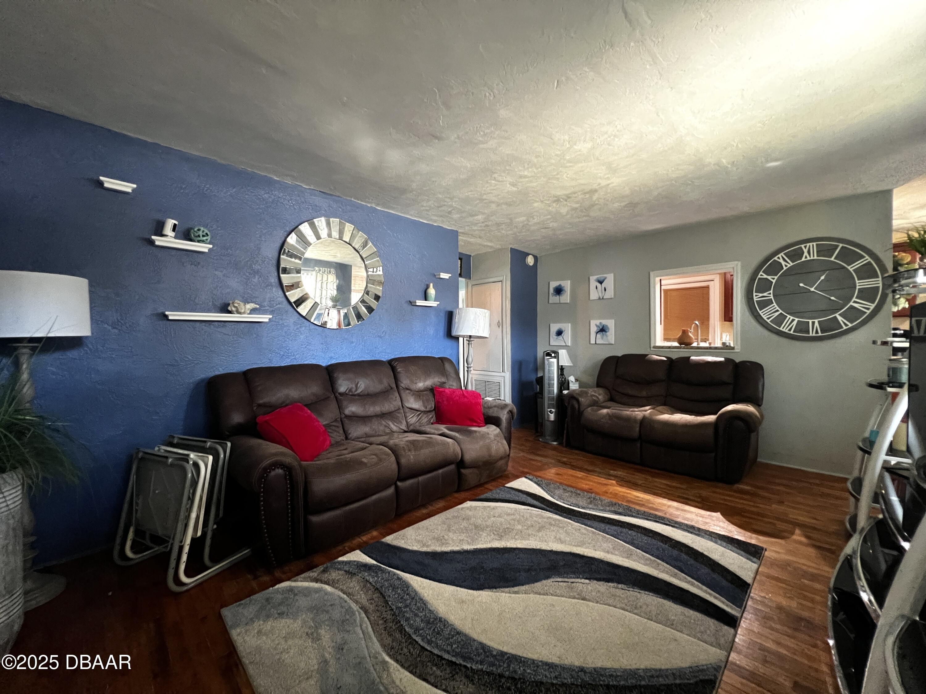 601 Berkshire Road Daytona Beach, FL 32114 - Photo 11 of 21 a living room with furniture a rug and wall paintings