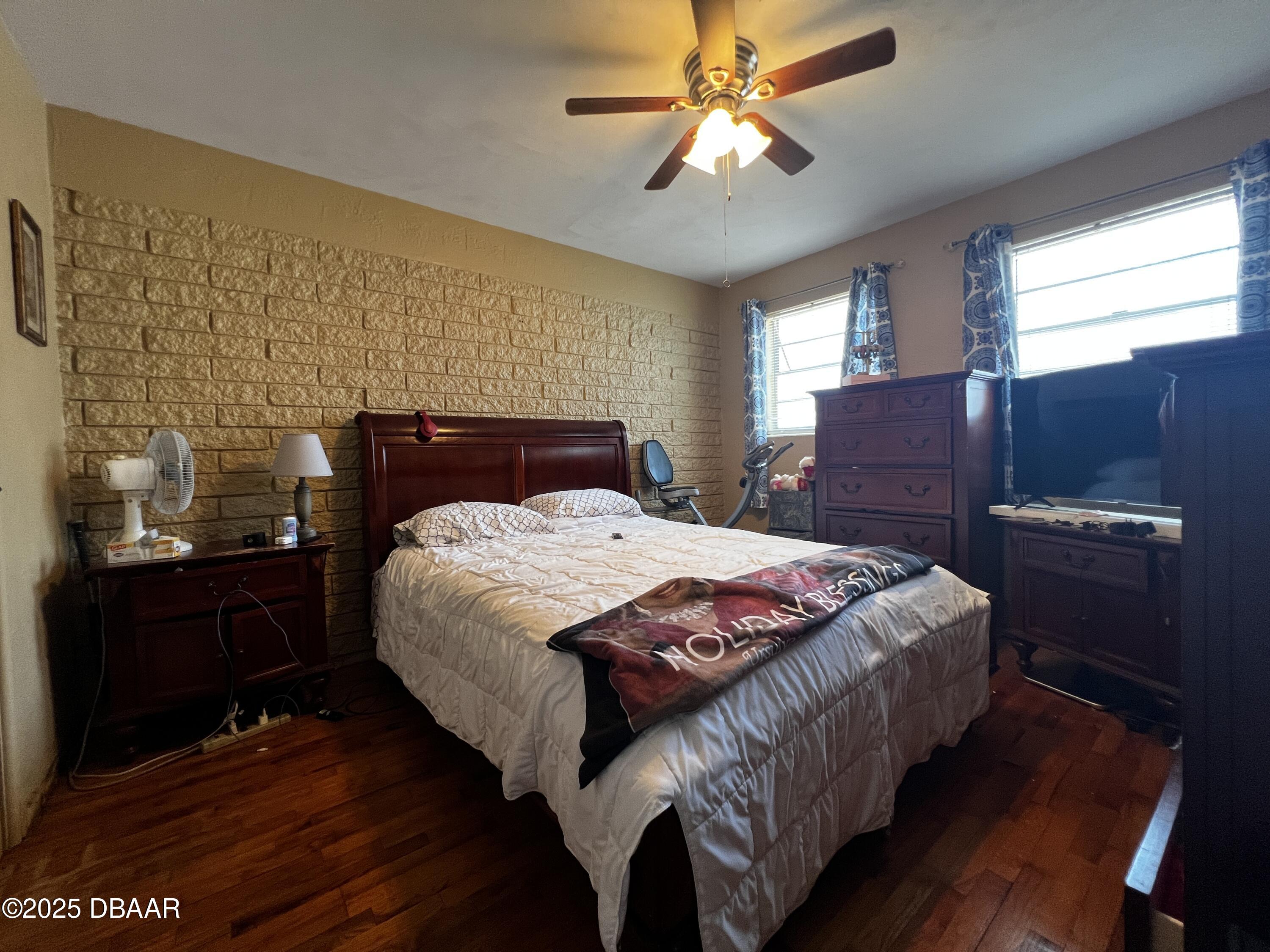 601 Berkshire Road Daytona Beach, FL 32114 - Photo 13 of 21 a bedroom with a bed and wooden floor