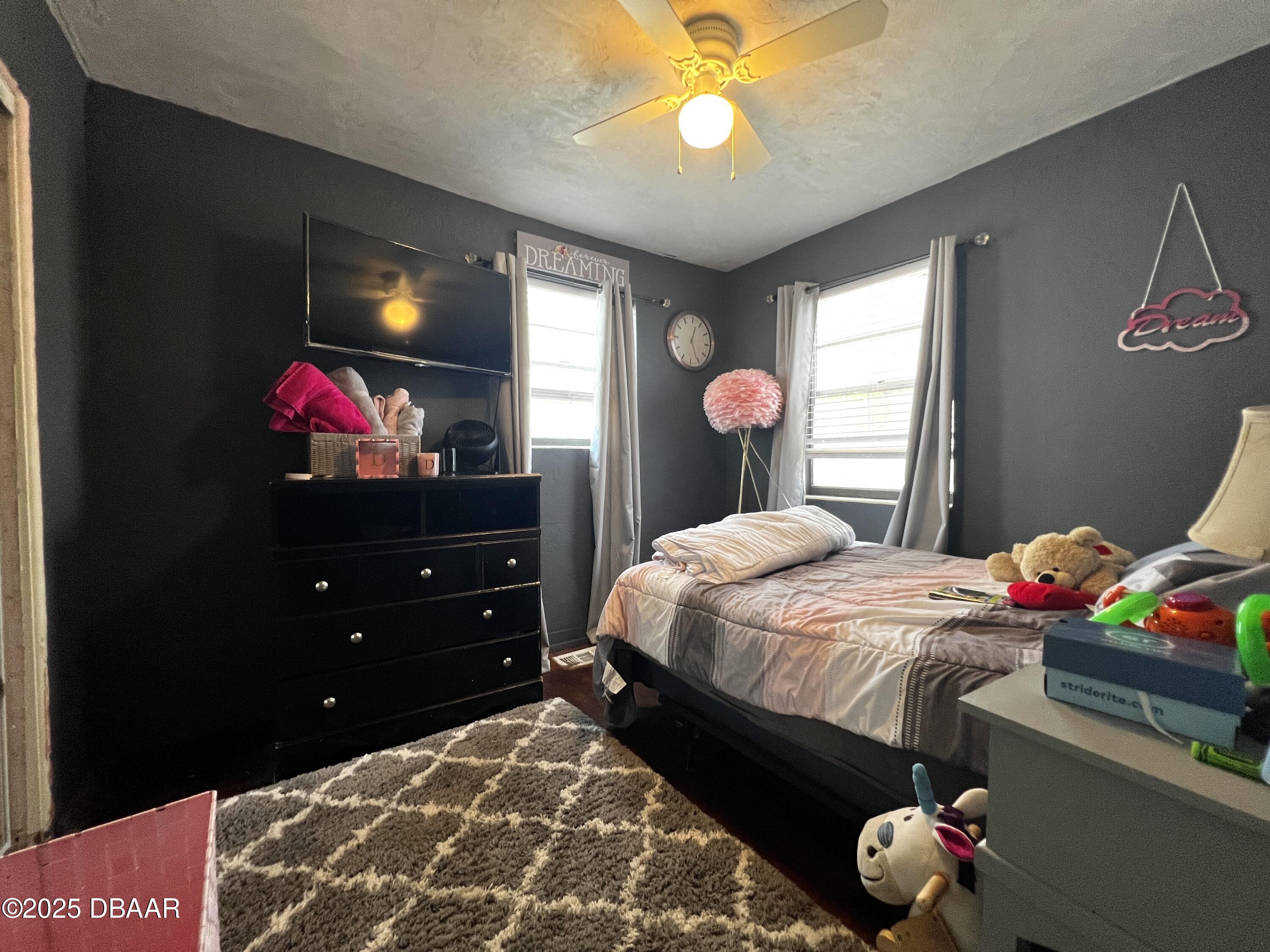 601 Berkshire Road Daytona Beach, FL 32114 - Photo 15 of 21 a bedroom with a bed and a dresser