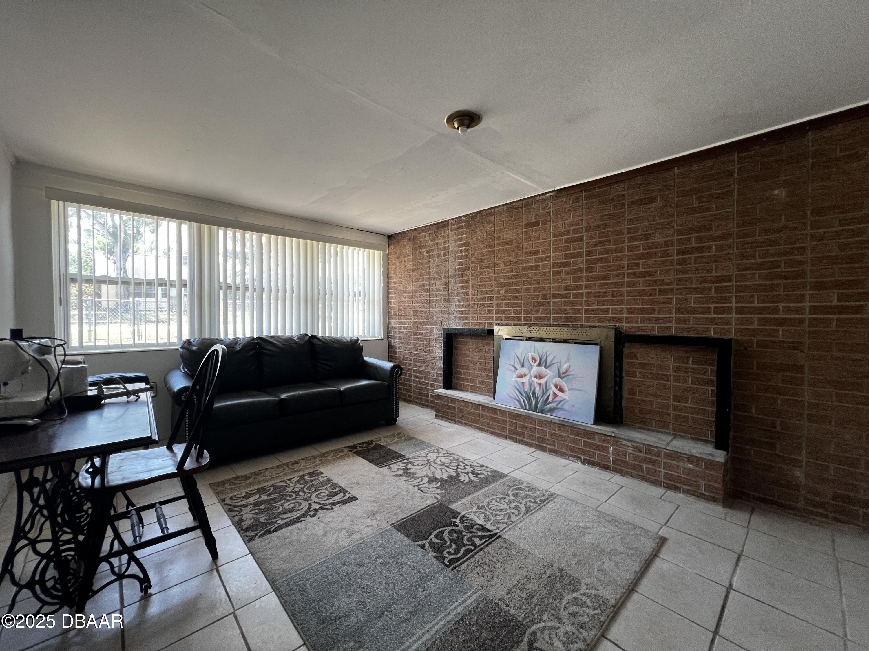601 Berkshire Road Daytona Beach, FL 32114 - Photo 17 of 21 a living room with furniture and a fireplace