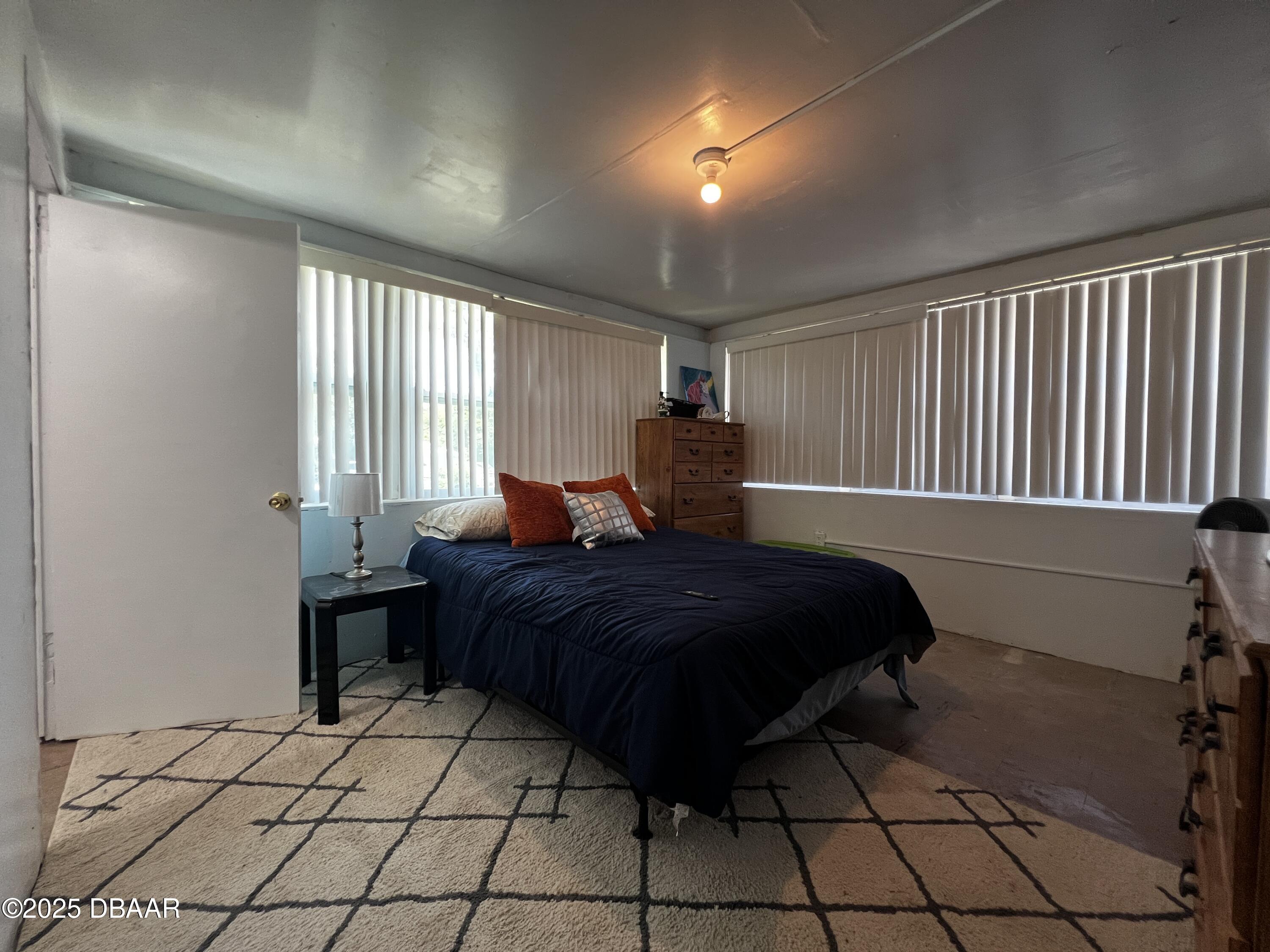 601 Berkshire Road Daytona Beach, FL 32114 - Photo 18 of 21 a bedroom with a bed and a window