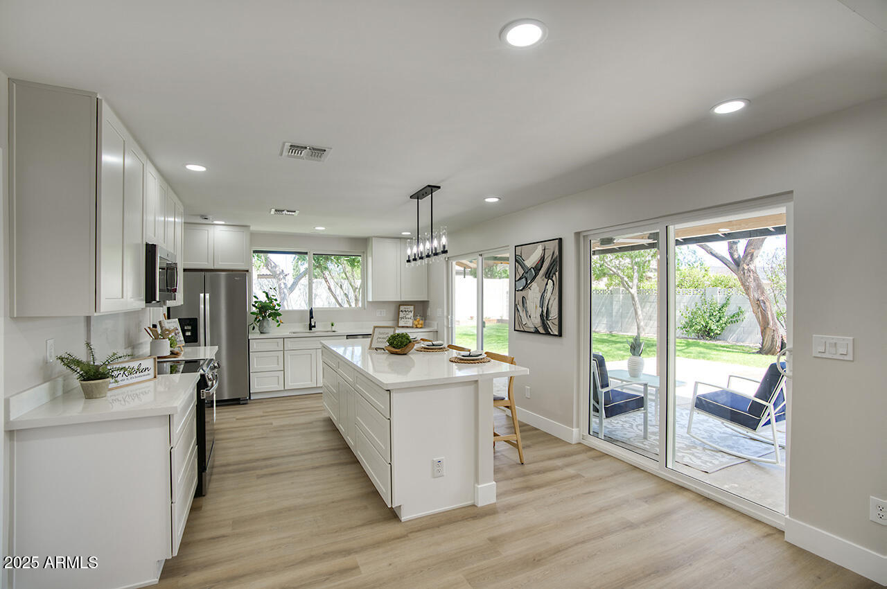 1561 North 26th Street Mesa, AZ 85213 - Photo 11 of 35 a kitchen with a sink and wooden floor