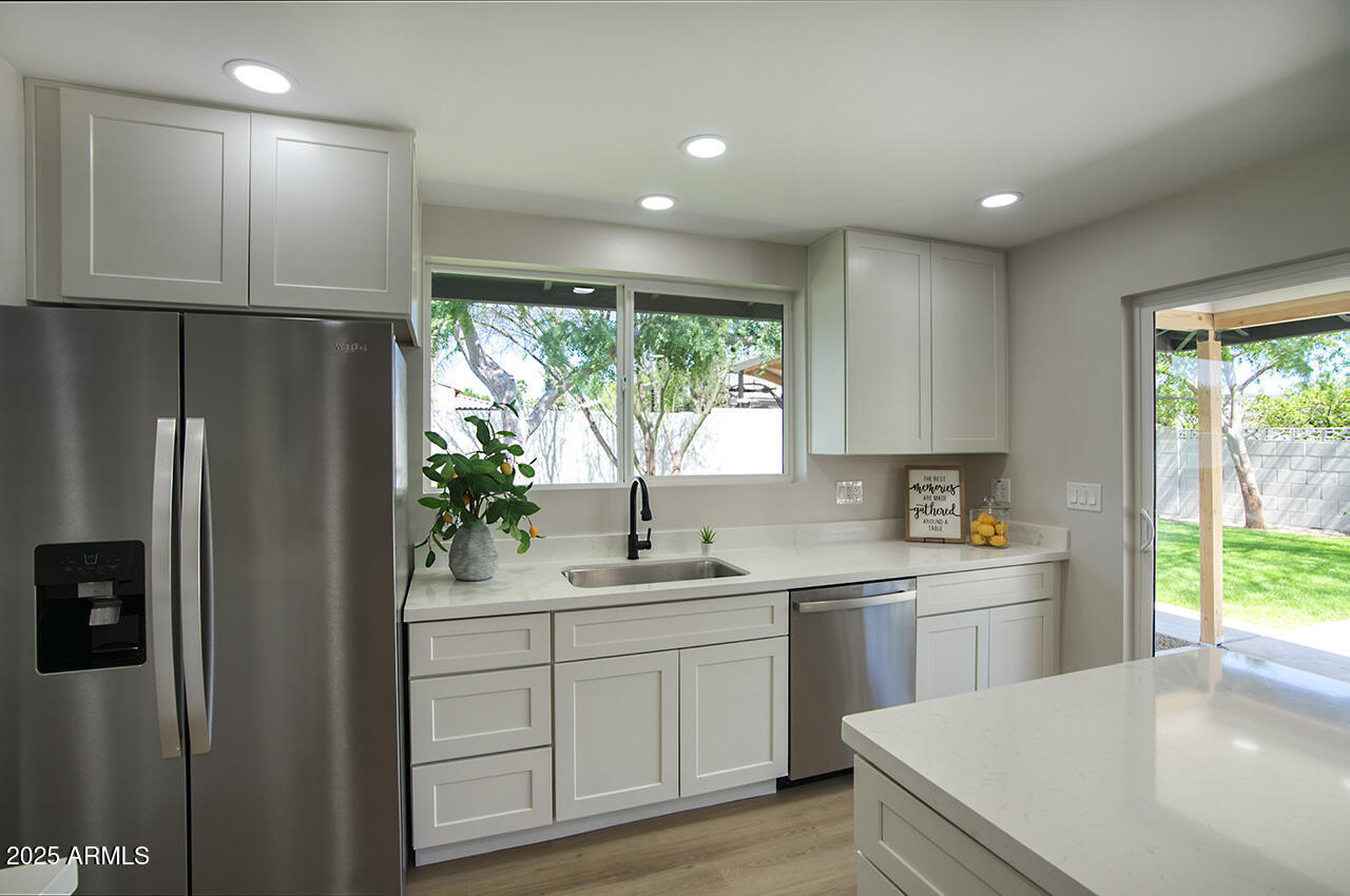 1561 North 26th Street Mesa, AZ 85213 - Photo 15 of 35 a kitchen with a sink a refrigerator and window