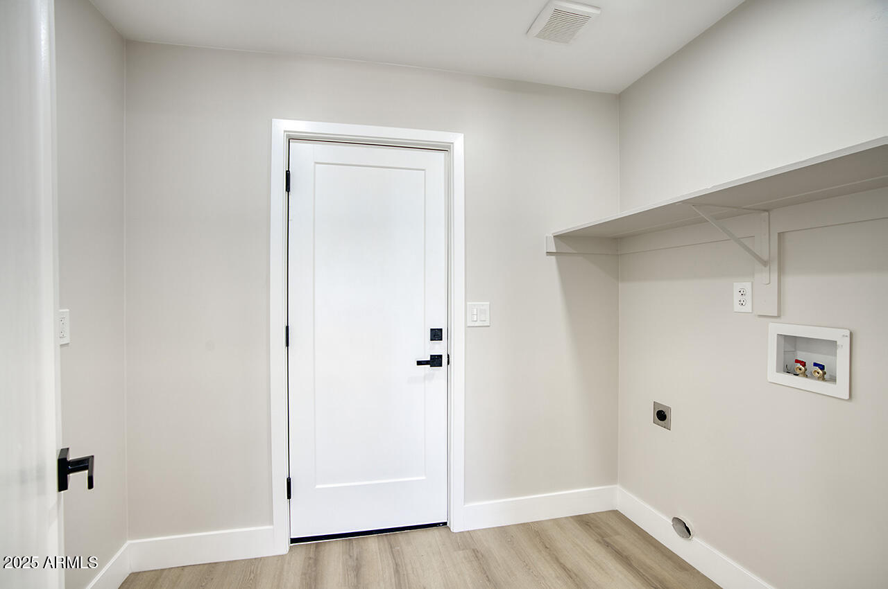 1561 North 26th Street Mesa, AZ 85213 - Photo 17 of 35 a view of a hallway with wooden floor