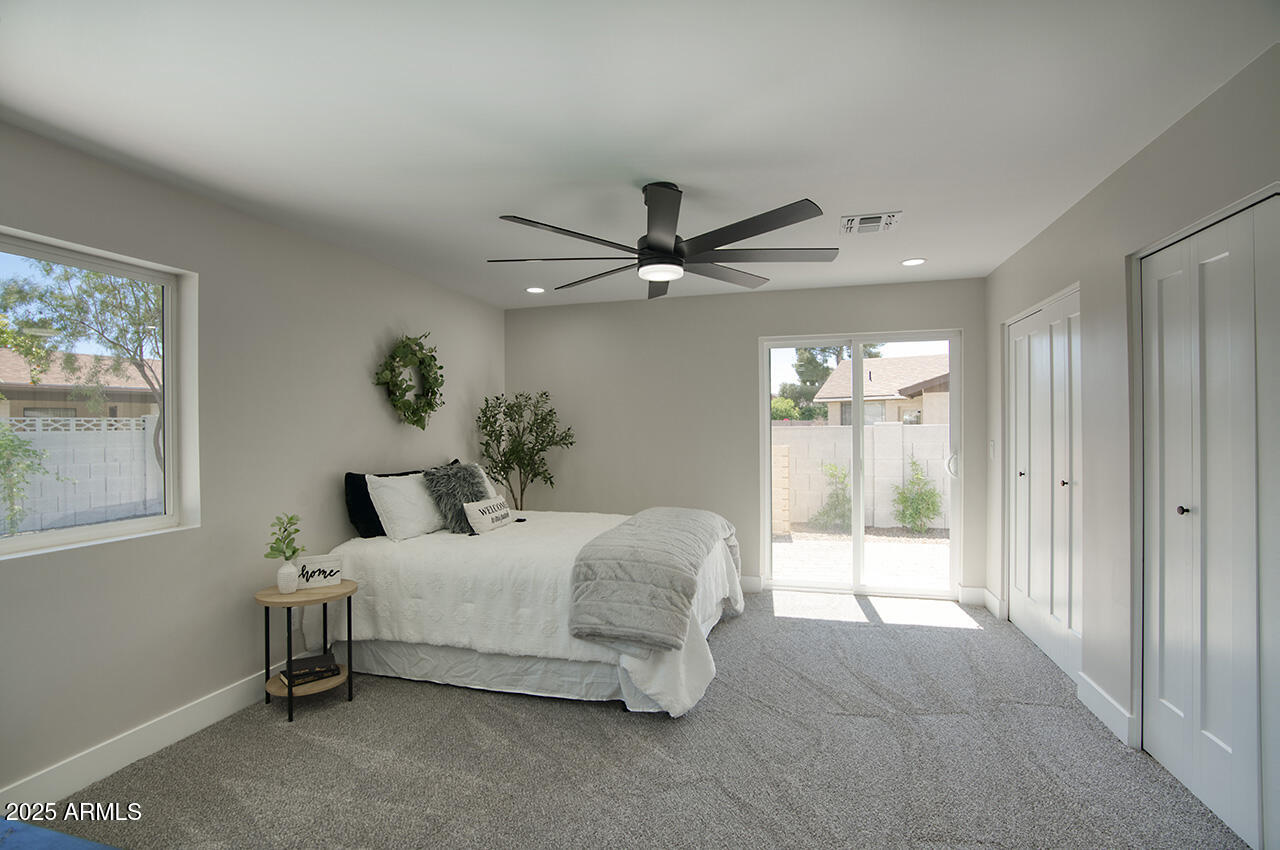 1561 North 26th Street Mesa, AZ 85213 - Photo 19 of 35 a bedroom with a bed and a chandelier