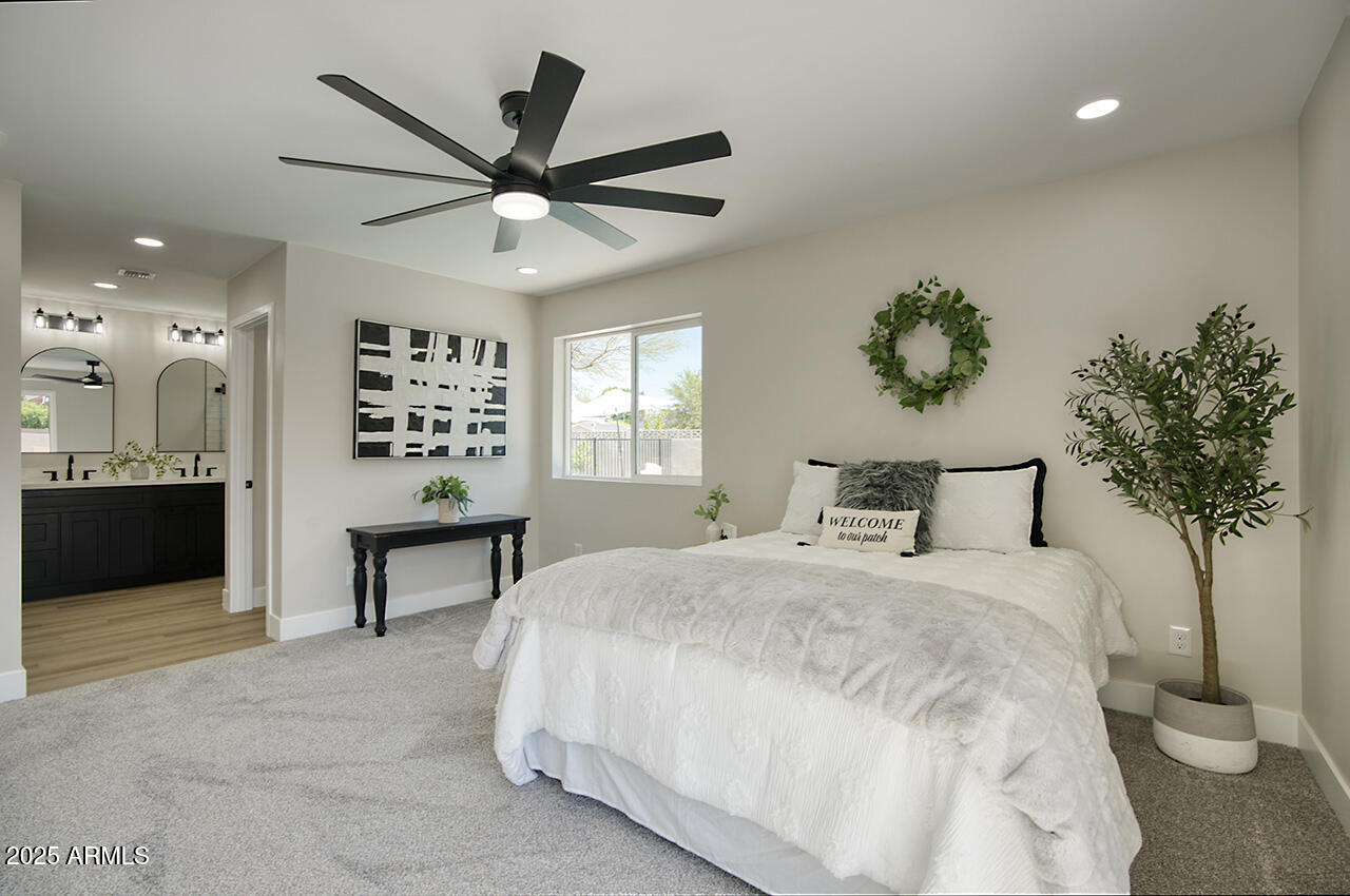 1561 North 26th Street Mesa, AZ 85213 - Photo 20 of 35 a bedroom with a bed and a chandelier