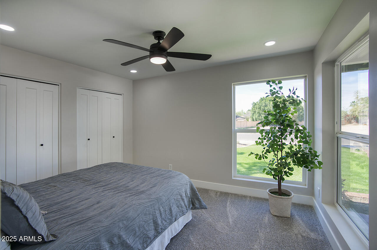 1561 North 26th Street Mesa, AZ 85213 - Photo 24 of 35 a bedroom with a bed and a potted plant